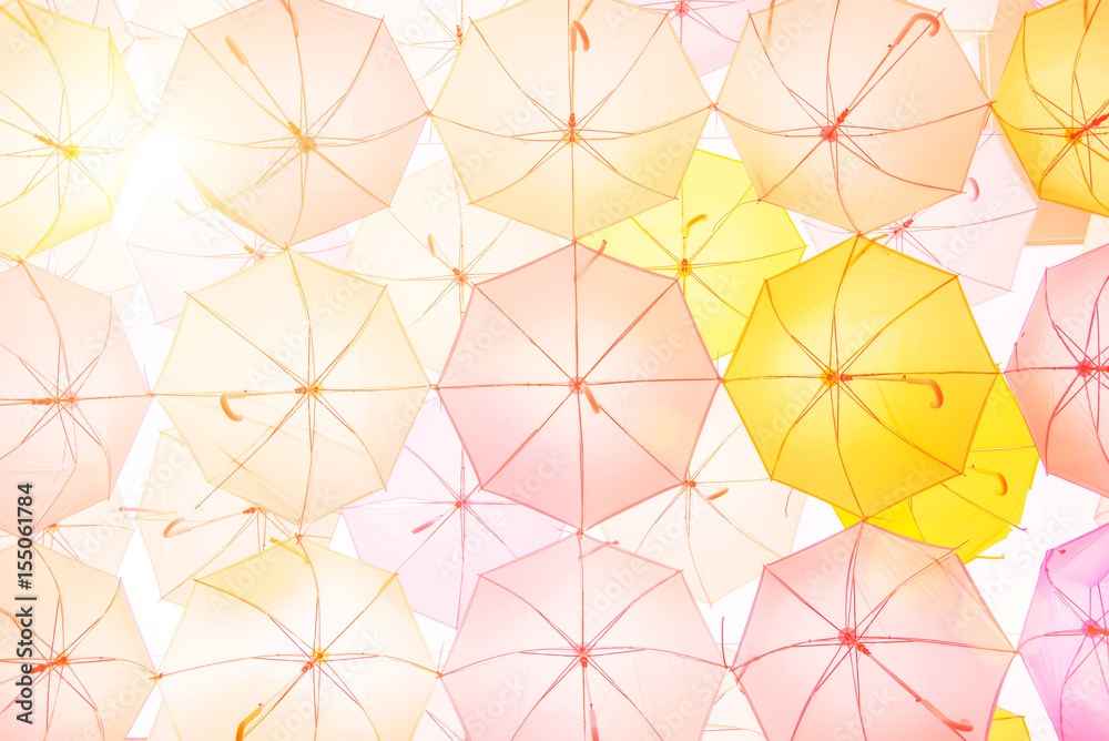 Lots of colorful umbrellas flying in sky over city street during summer festival. Fun and happy background concept. Vintage and retro threme. Lots of colorful umbrellas flying in sky over city street during summer festival. Fun and happy background concept. Vintage and retro threme.