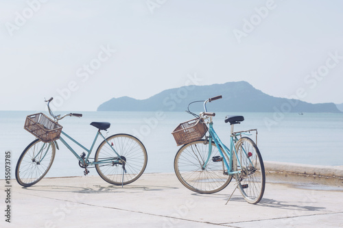 vintage bicycle on concrete road   beach over blue sea and clear blue sky background, spring or summer holiday vacation concept.soft focus © lesterman