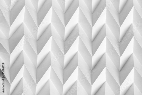 Closeup abstract white folded origami geometrical jigsaw paper pattern background