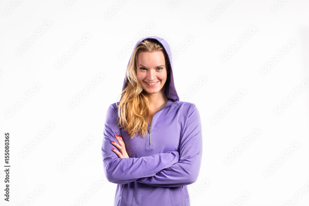 Young fitness woman in purple sweatshirt. Studio shot. Young fitness woman in purple sweatshirt. Studio shot.