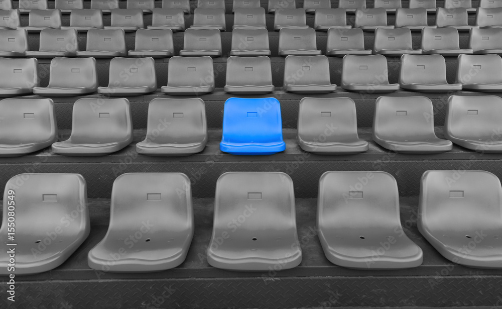Fototapeta premium stadium seats with one highlighted on blue