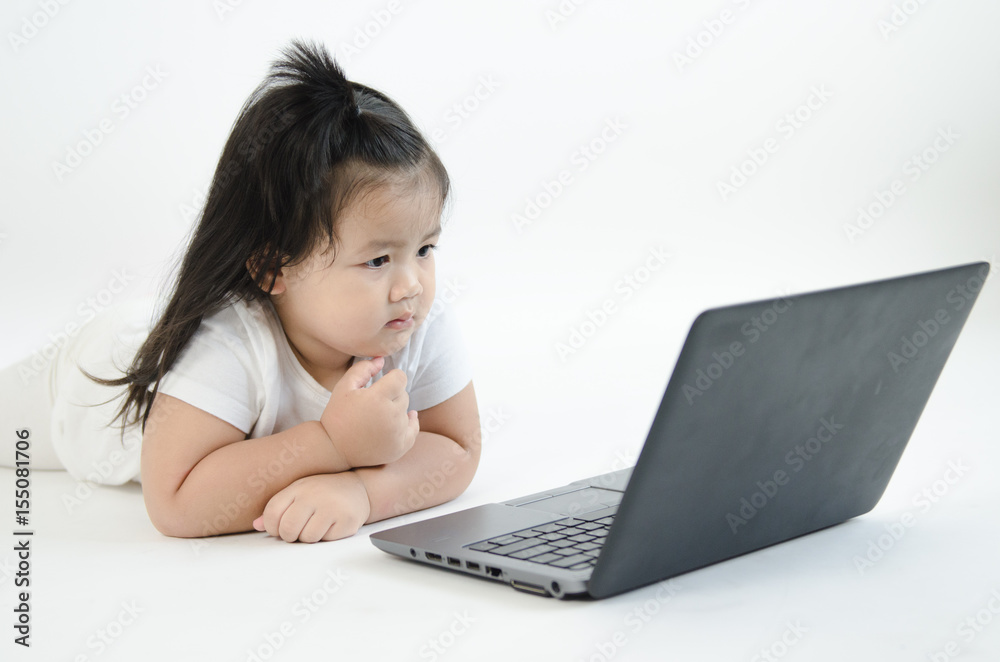 Asian child playing on computer laptop Asian child playing on computer laptop