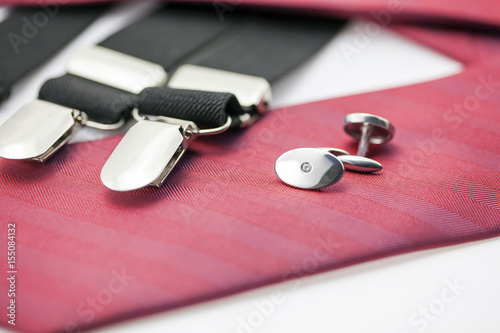 Elegant male cufflinks on the red tie photo