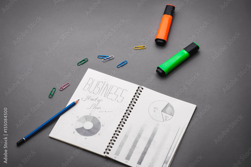 Creative sketch in spiral notepad with laptop on desk. Business starup plan. Creative sketch in spiral notepad with laptop on desk. Business starup plan.