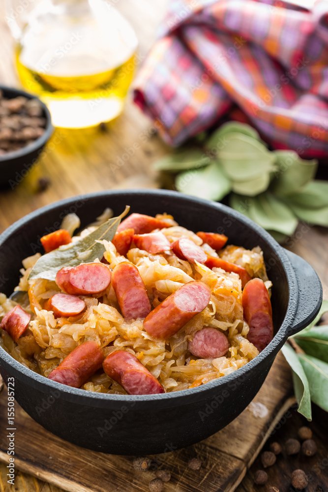 Cabbage braised with sausages, sauerkraut. German cuisine. Cabbage braised with sausages, sauerkraut. German cuisine.