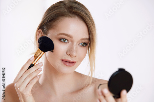 Face Beauty. Woman Applying Makeup Powder With Cosmetic Brush