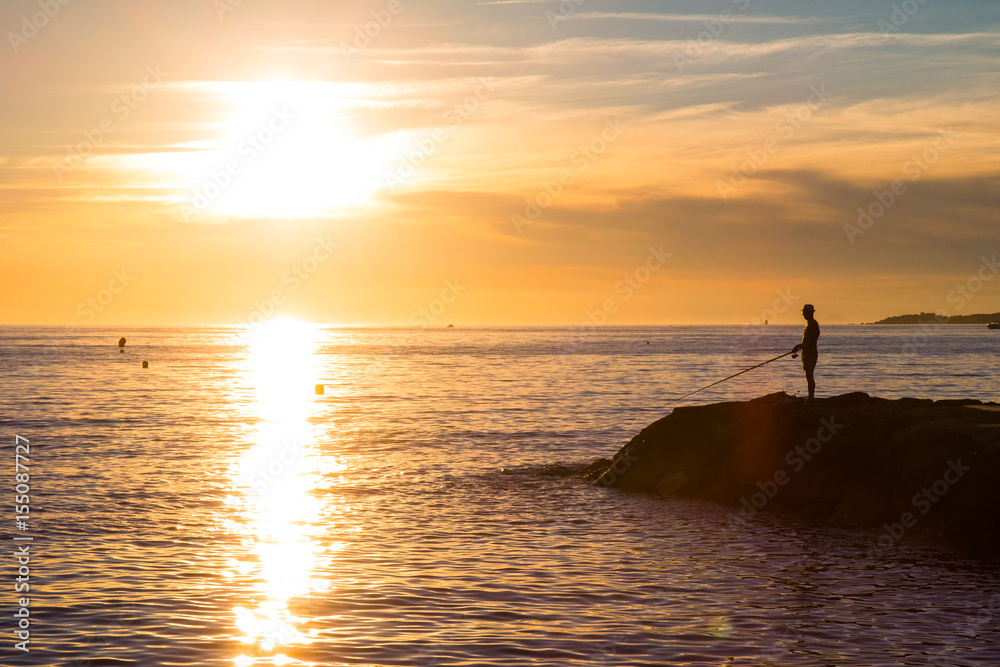 Silhouette of man fishing in Mediterranean, France