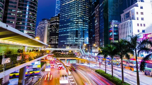 Busy City Night Timelapse. Central. Hong Kong. China. Office buildings with busy traffic at rush hour. Many busy people on sidewalk and footbridge andine up for the public transport. photo
