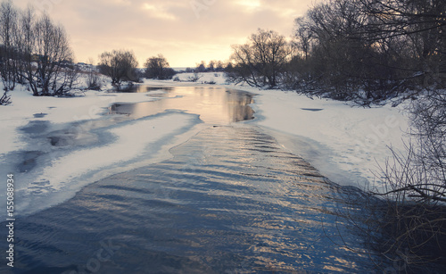 Winter landscape with flowing river © valeriy boyarskiy