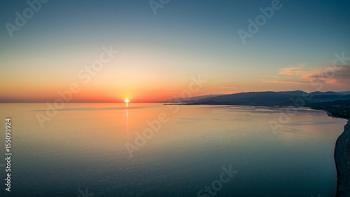 Sunset over a calm sea from the height of bird flight