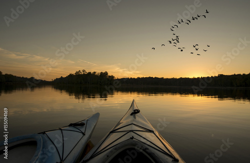 Kayaks at Sunset with Geese Flying
