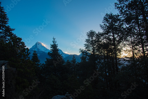  poon hill Sunset and sunrise in the mountains with a forest view, showcasing snow-capped peaks, misty fog, and a scenic landscape