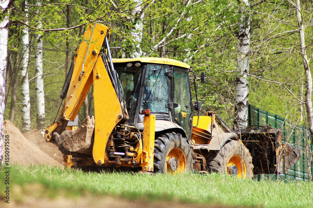 Yellow excavator on a construction site Yellow excavator on a construction site