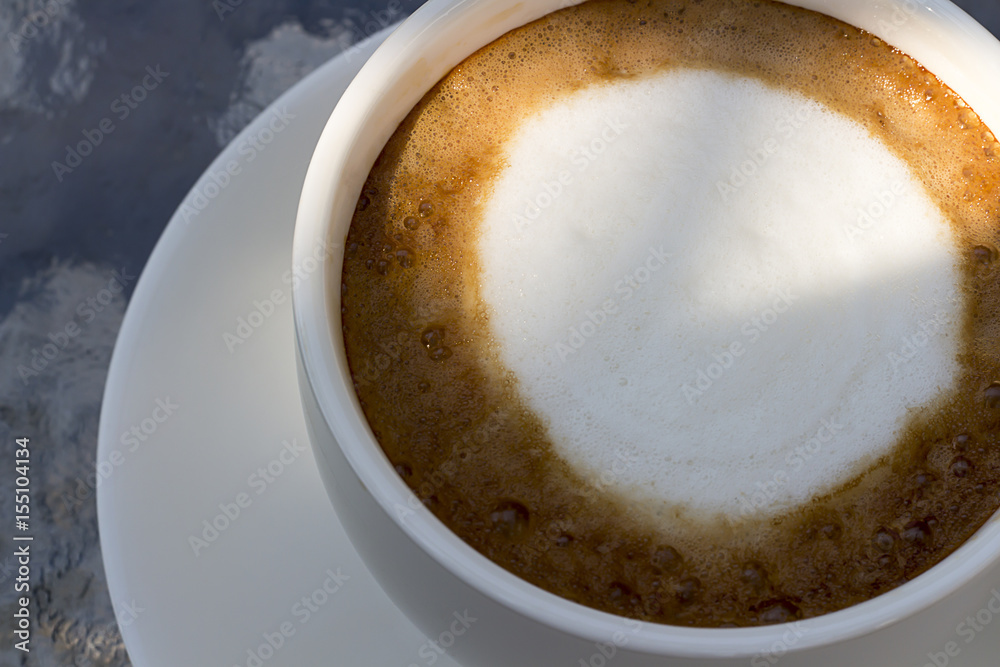 Hot coffee and coffee bubble in a white cup on a table Hot coffee and coffee bubble in a white cup on a table