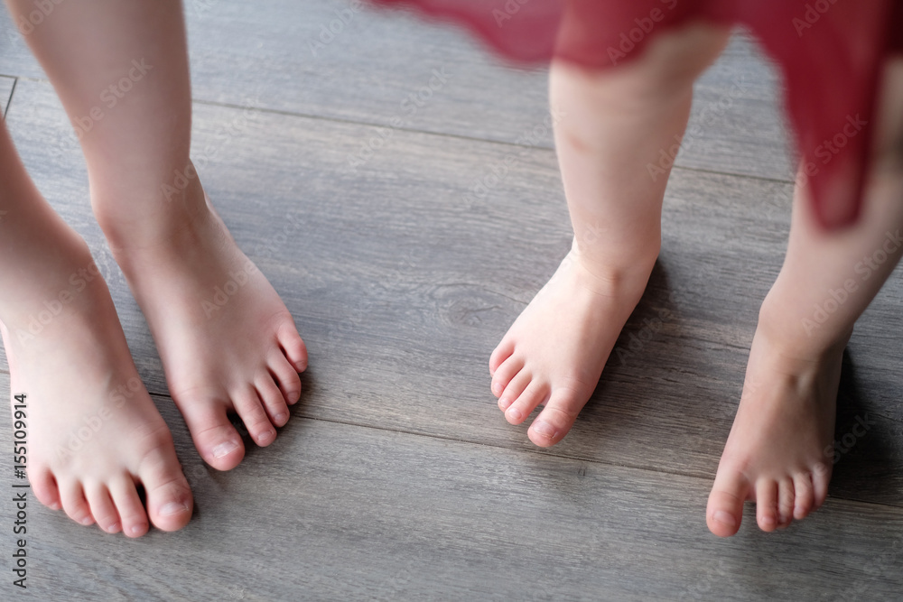 Children's bare feet on the wooden floor in dance studio