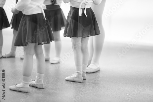 Little children are engaged in a dance studio with a choreographer.
