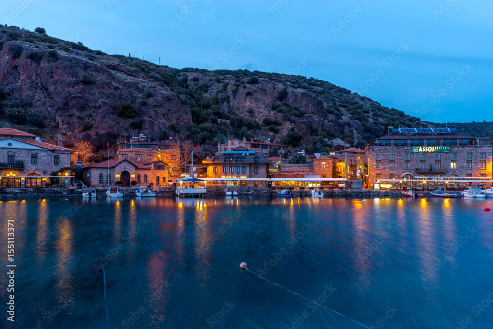 Behramkale Assos ,Turkey : sunset at ancient harbour with hotels and fishing boats
