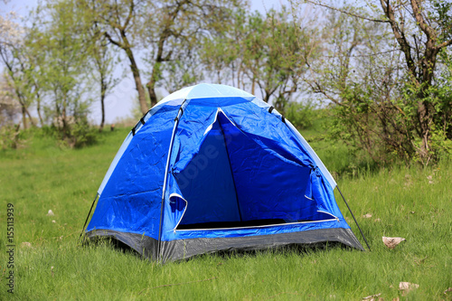tourist tent on green meadow