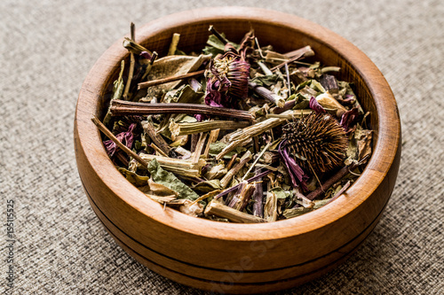 Dried Echinacea Purpurea Root in wooden bowl.
