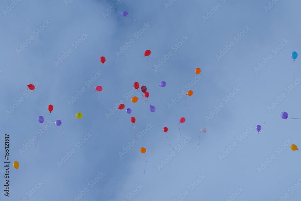 Multicolored balloons flying in the sky.