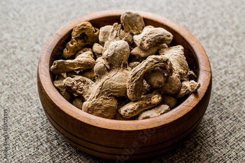 Dry Ginger in wooden bowl. photo