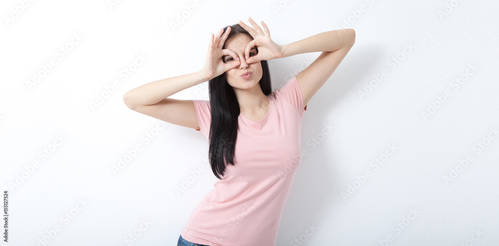 Naughty girl looking through binoculars. Invitation to see the world. Naughty girl looking through binoculars. Invitation to see the world.