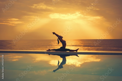 Asian woman practice yoga on the beach sunrise © chayathon2000