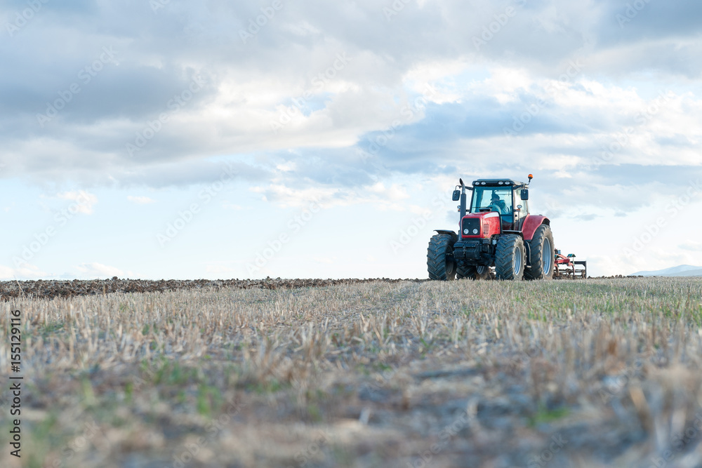 agricultural machinery working the land in the field.