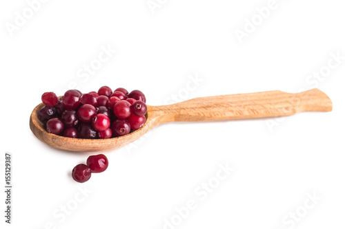 Cranberries in a spoon on a white background