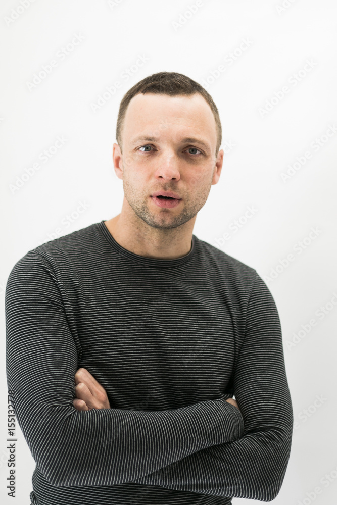 Talking young European man over white wall Talking young European man over white wall