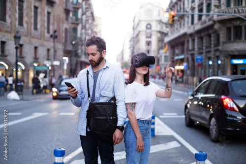 Serious and concentrated couple or two friends or coworkers analize the environment around them with the Virtual reality googles