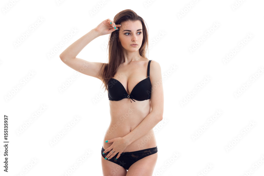 young hot girl stands in black lingerie with nice natural breasts keeps the  arm near the face and looks toward Stock Photo | Adobe Stock