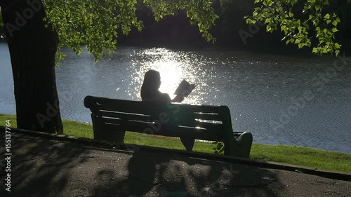 Young woman reading a book in the park