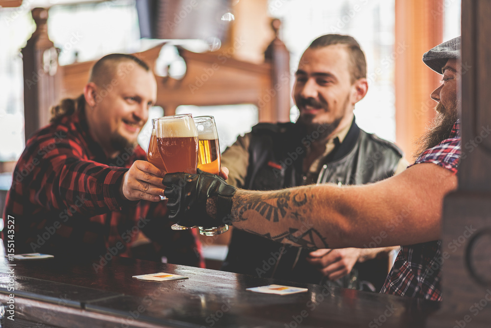 Joyful males drinking in bar