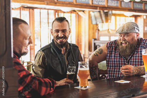 Pleasant adult males talking in pub