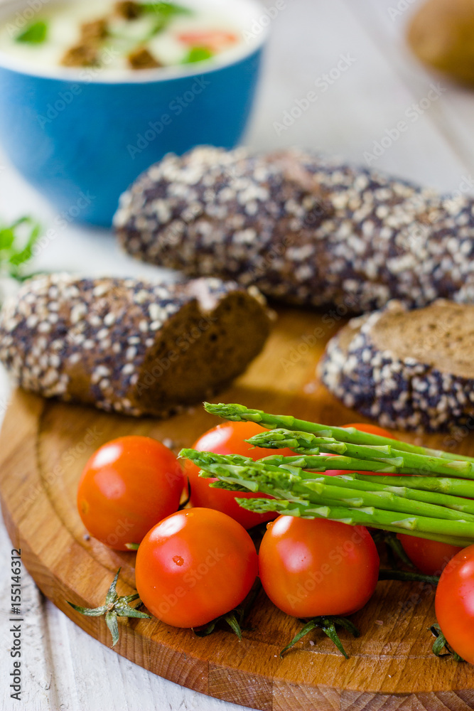 Fresh asparagus, bread and tomatoes Fresh asparagus, bread and tomatoes