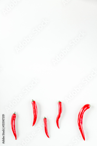 hot food with red chili on white table background top view mock up