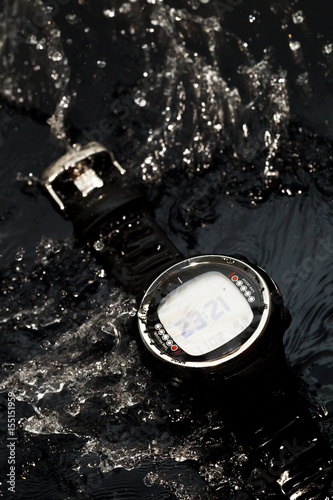 Watches for scuba diving in streams of water on a black background, studio light photo