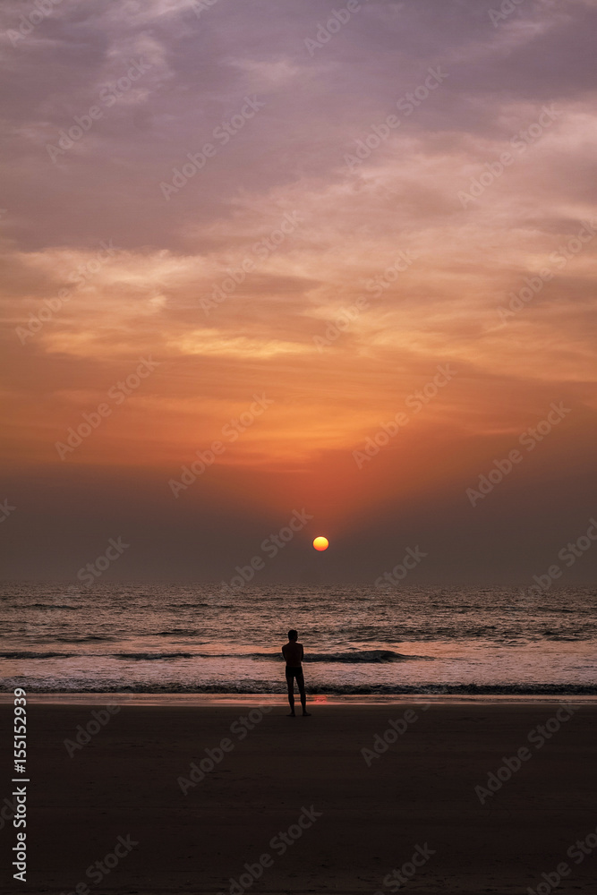 male watching sunset