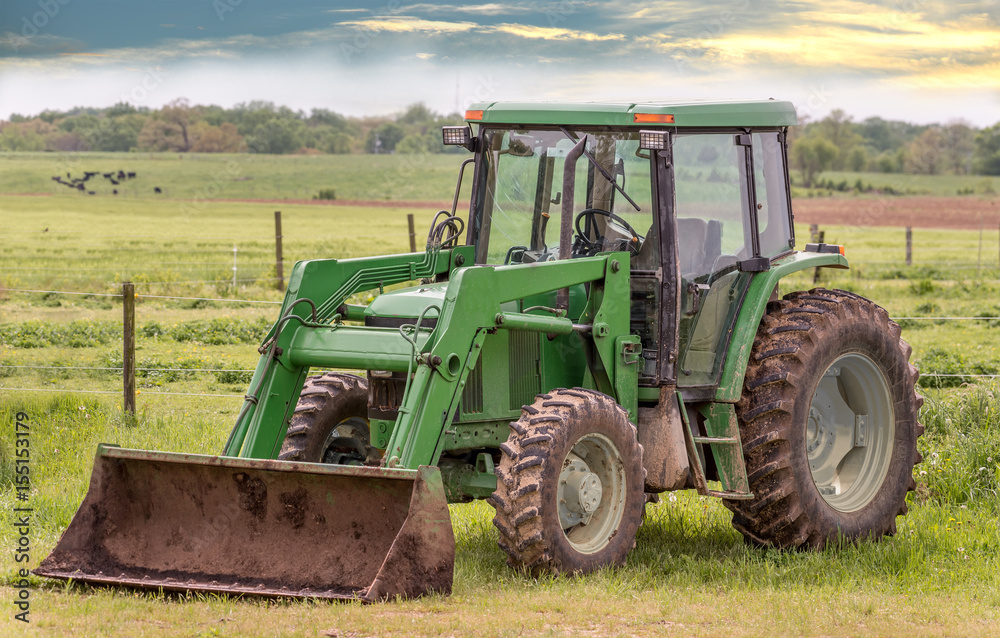 Fototapeta premium Tractor in a field on a rural Maryland farm during Spring