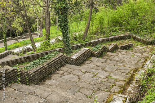 Paths with stairs in park covered with stone slabs in springtime