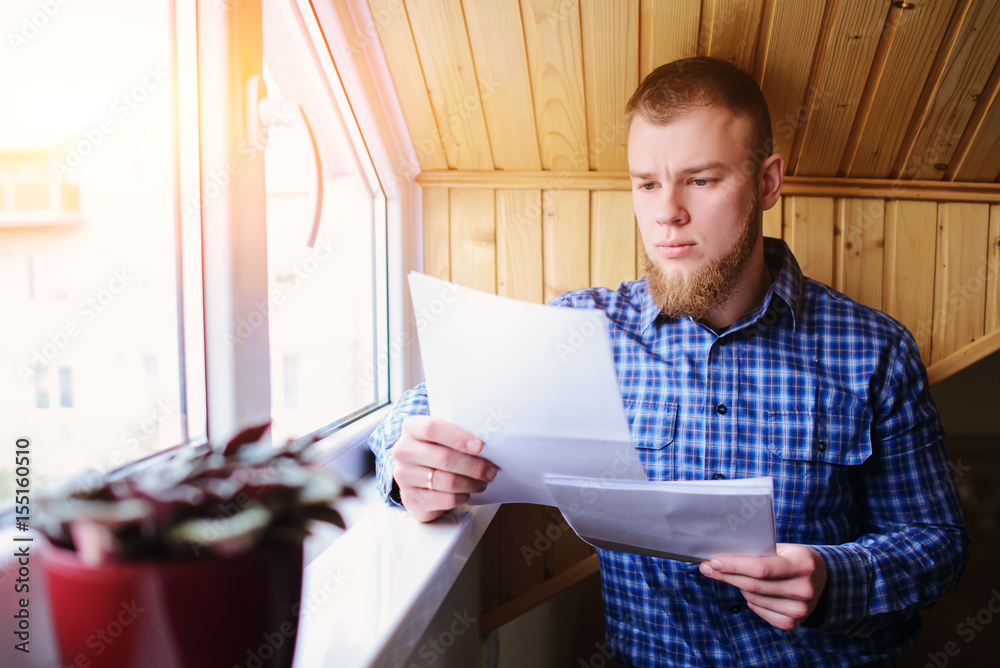 Businessman at home, he is working with of paper Businessman at home, he is working with of paper
