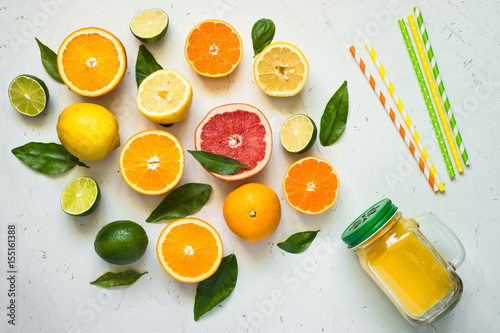 Citrus juice smoothie and ingredients. Fresh Fruit background on white.