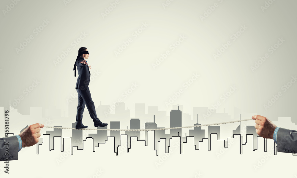 Business concept of risk support and assistance with man balancing on rope Business concept of risk support and assistance with man balancing on rope