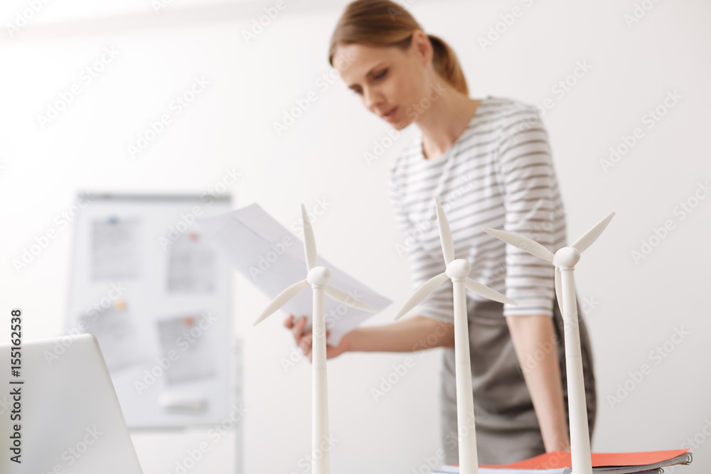 Concentrated woman working on the wind turbines project Concentrated woman working on the wind turbines project