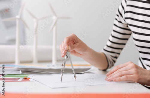 Professional female engineer drawing a blueprint photo