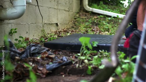 Wallpaper Mural HVAC technician prepares pad cushion for new air conditioner unit near side of home Torontodigital.ca