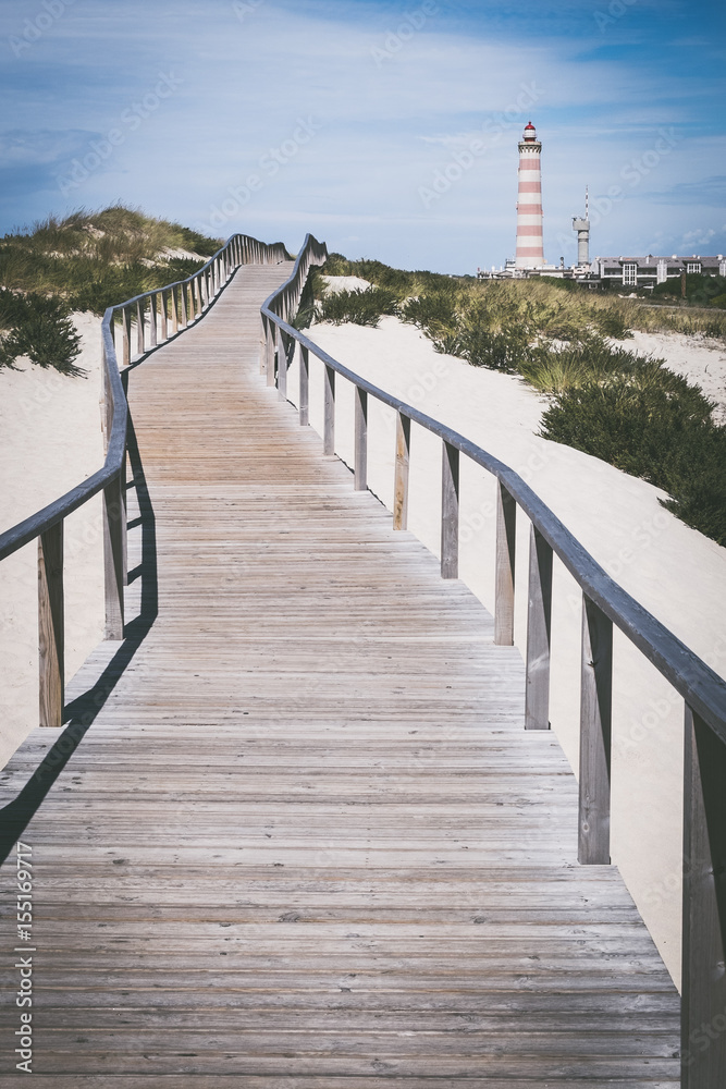 Praia da Barra Portuguese lighthouse on coast, Symbol of city Barra, Surfing beach area Barra, Wooden pier at beach, Wooden bridge for runners, Symbol of Portuguese summer vacation