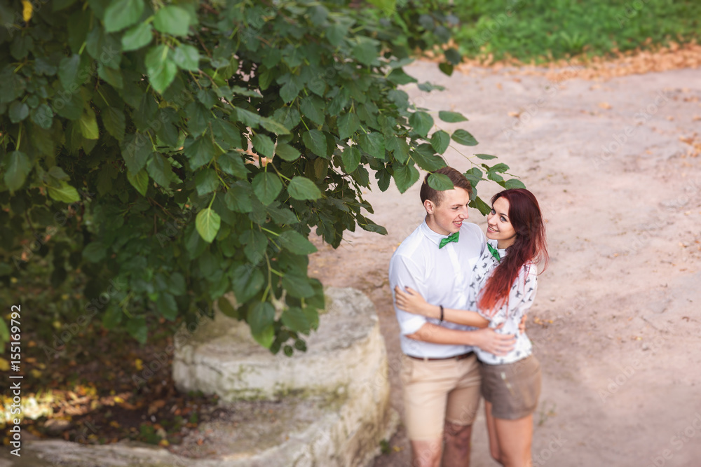 Young couple in love embracing in park, happy people outdoors Young couple in love embracing in park, happy people outdoors