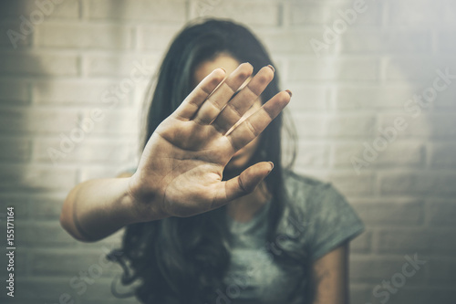 Young woman showing her denial with NO on her hand photo